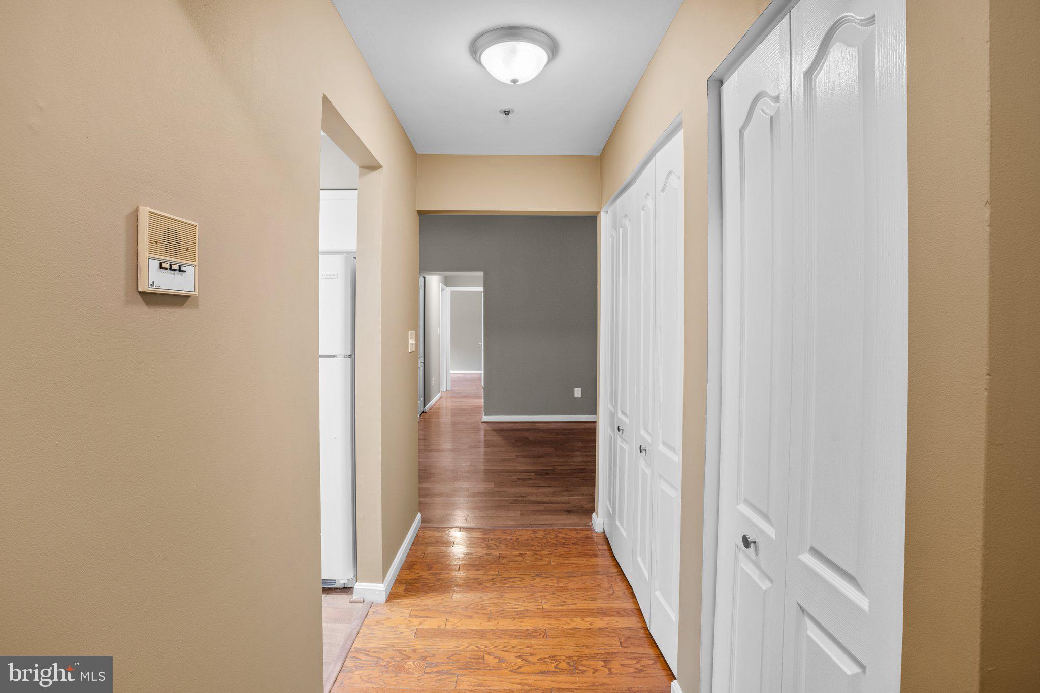 8335 Montgomery Run Road, Unit K Ellicott City, MD 21043 - Photo 25 of 42 a view of a hallway with wooden floor