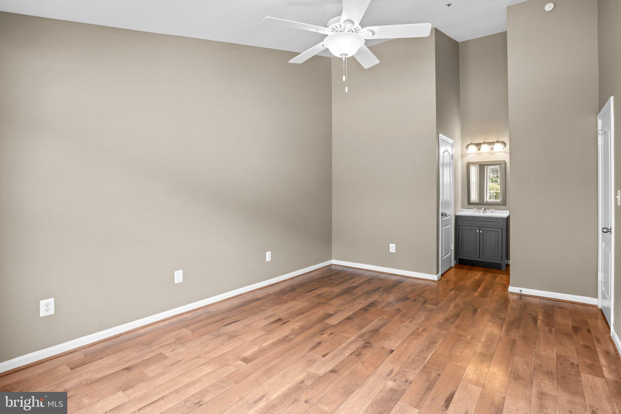 8335 Montgomery Run Road, Unit K Ellicott City, MD 21043 - Photo 27 of 42 wooden floor in an empty room with a window