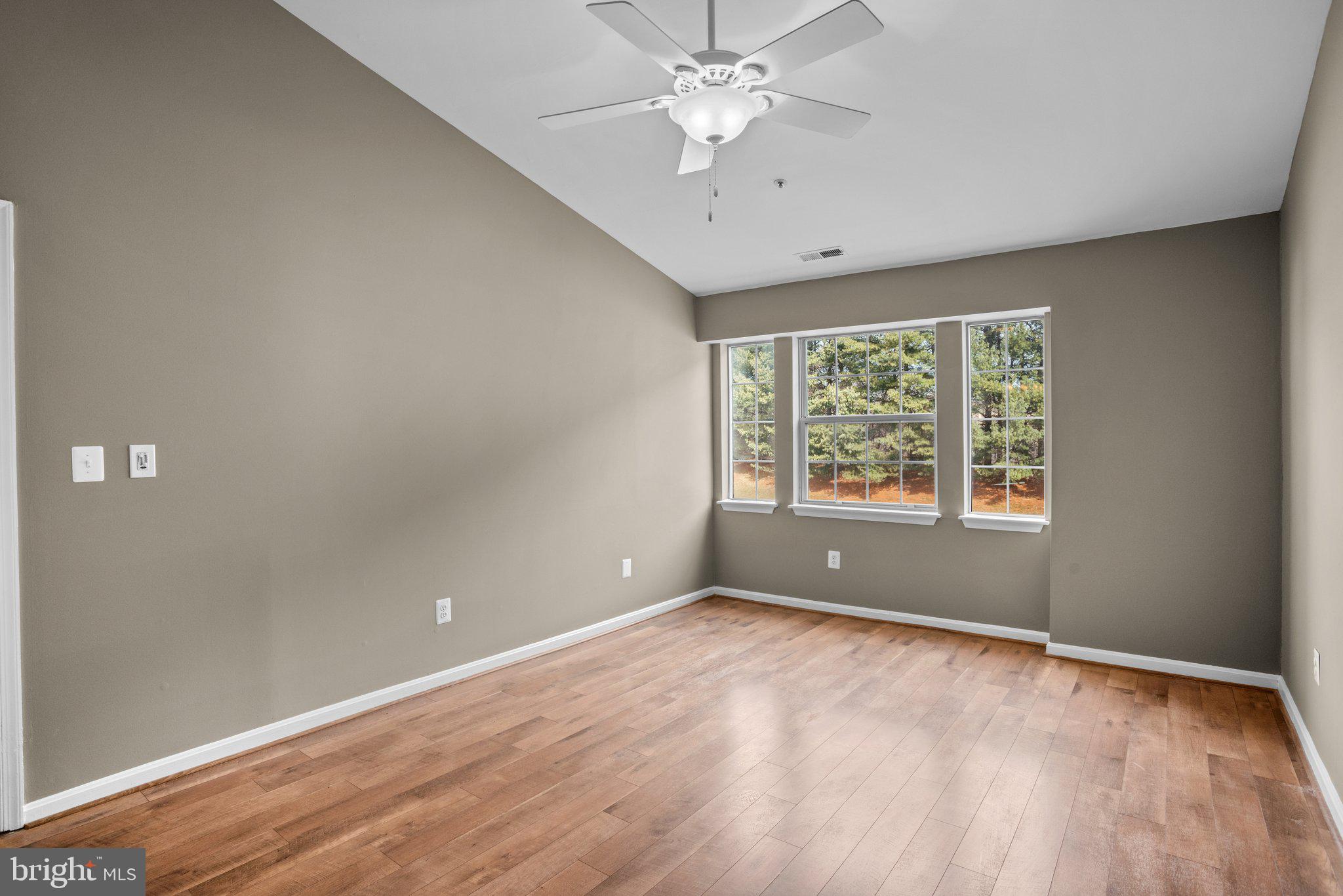 8335 Montgomery Run Road, Unit K Ellicott City, MD 21043 - Photo 29 of 42 wooden floor in an empty room with a window