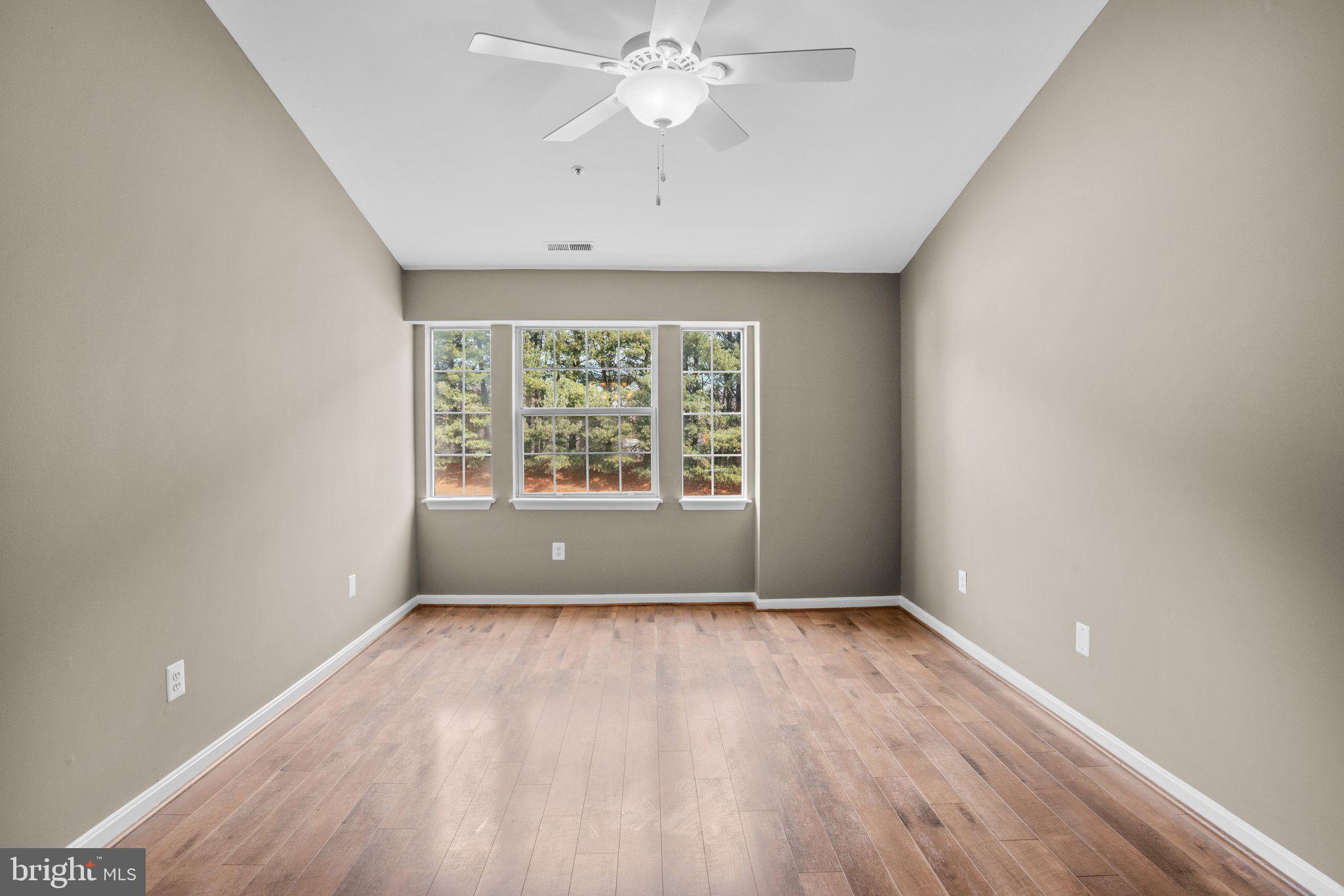 8335 Montgomery Run Road, Unit K Ellicott City, MD 21043 - Photo 30 of 42 wooden floor in an empty room with a window