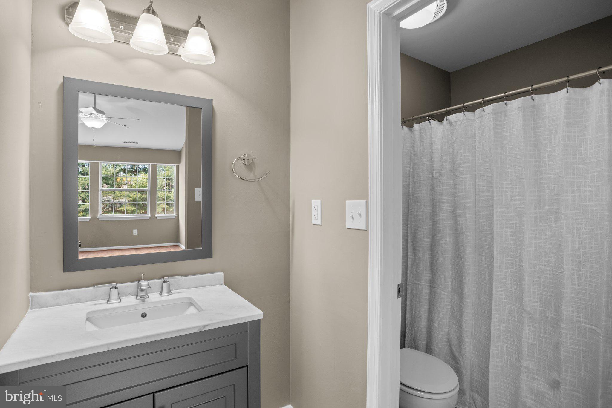 8335 Montgomery Run Road, Unit K Ellicott City, MD 21043 - Photo 32 of 42 a bathroom with a sink a toilet and shower