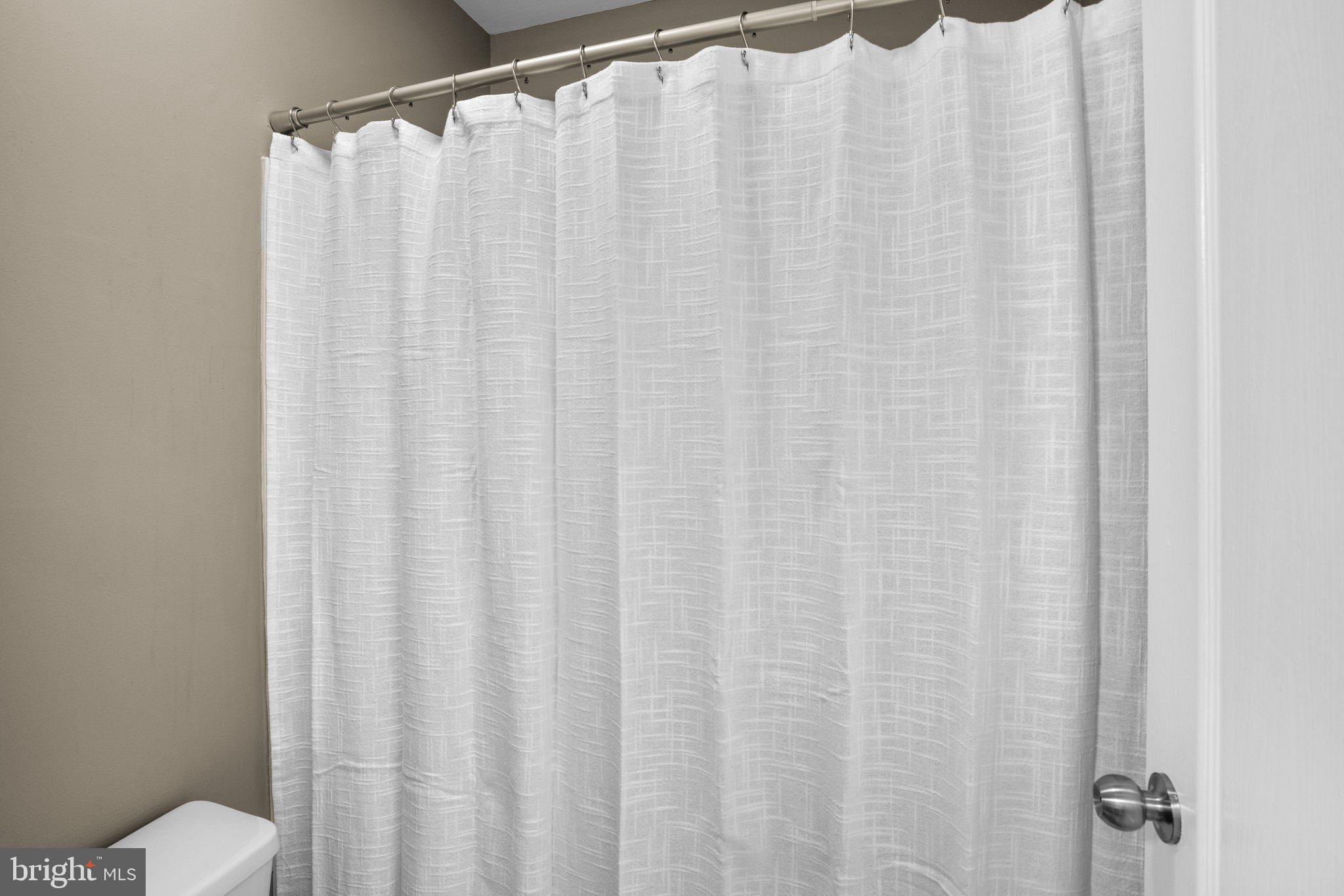 8335 Montgomery Run Road, Unit K Ellicott City, MD 21043 - Photo 33 of 42 a bathroom with a shower curtain and curtain curtain