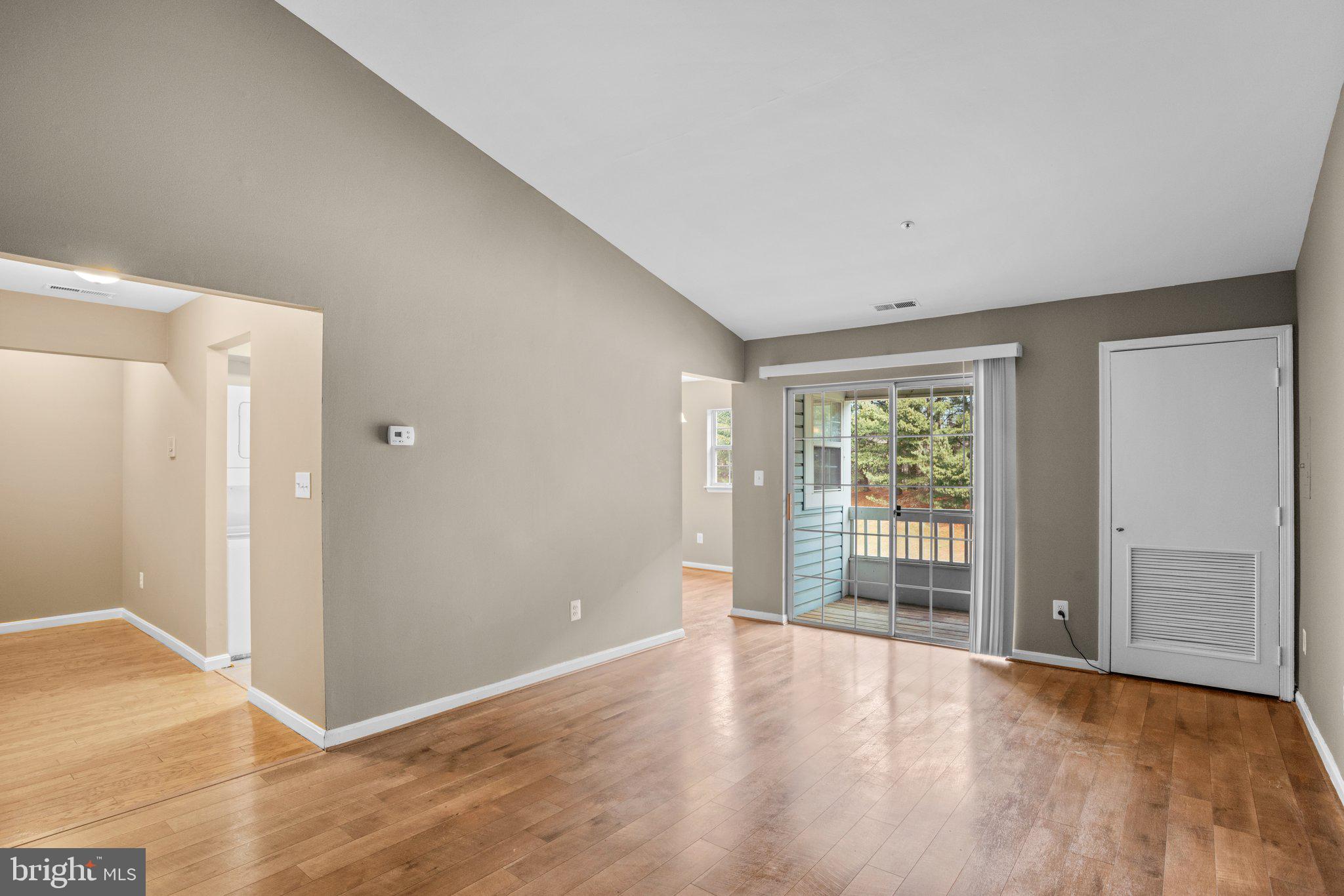 8335 Montgomery Run Road, Unit K Ellicott City, MD 21043 - Photo 4 of 42 a view of an empty room with wooden floor and a window