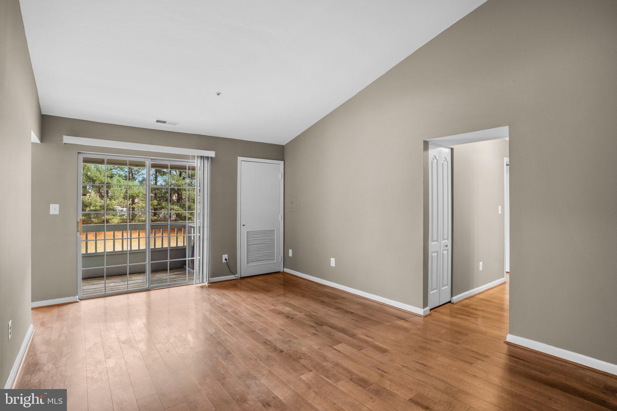 8335 Montgomery Run Road, Unit K Ellicott City, MD 21043 - Photo 6 of 42 a view of an empty room with wooden floor and a window