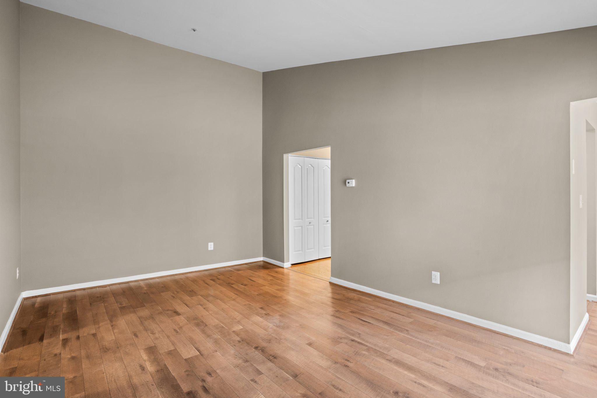 8335 Montgomery Run Road, Unit K Ellicott City, MD 21043 - Photo 9 of 42 a view of an empty room with wooden floor