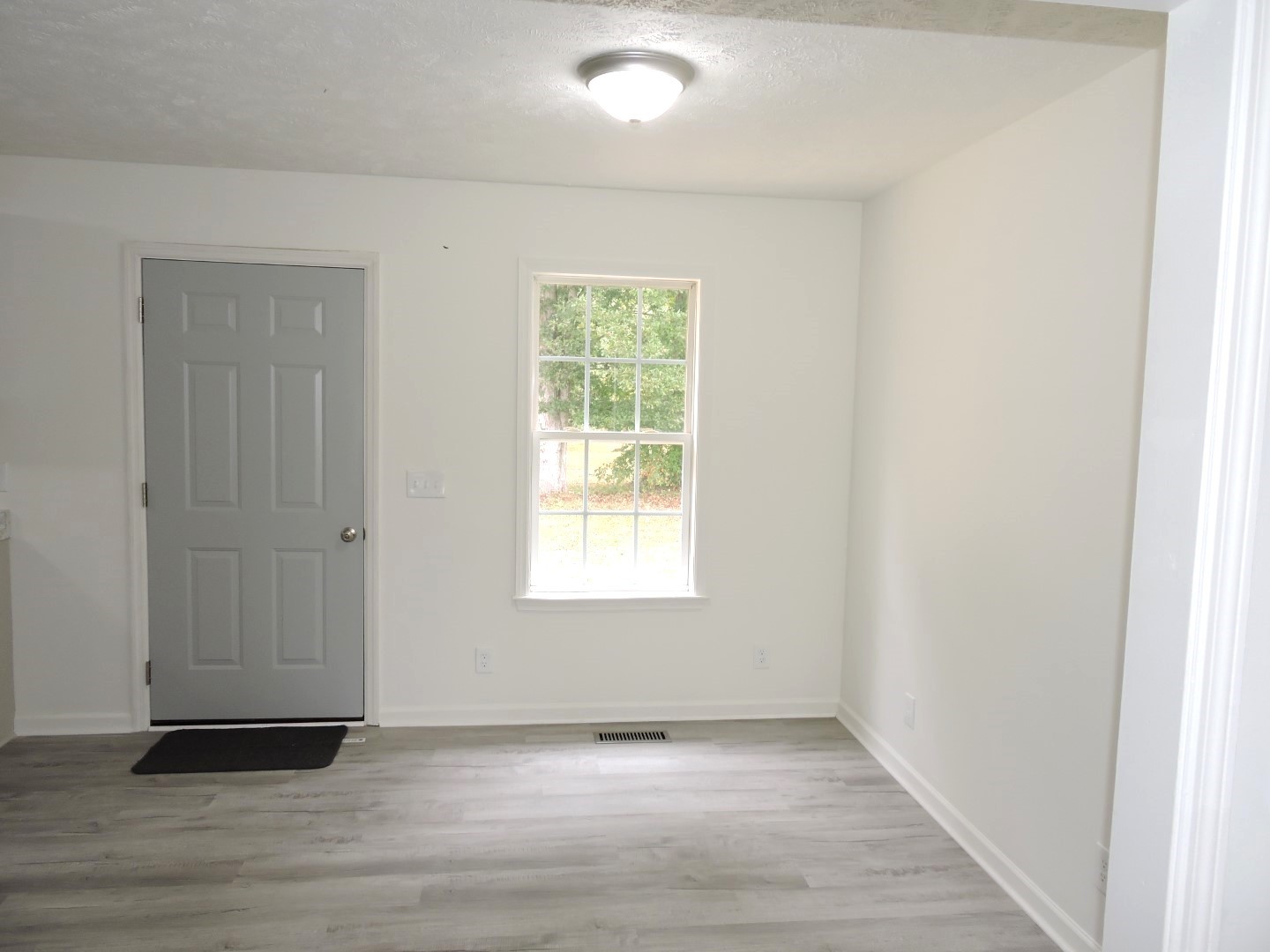 118 Ferrells Loop Road Manchester, TN 37355 - Photo 7 of 28 an empty room with wooden floor and windows