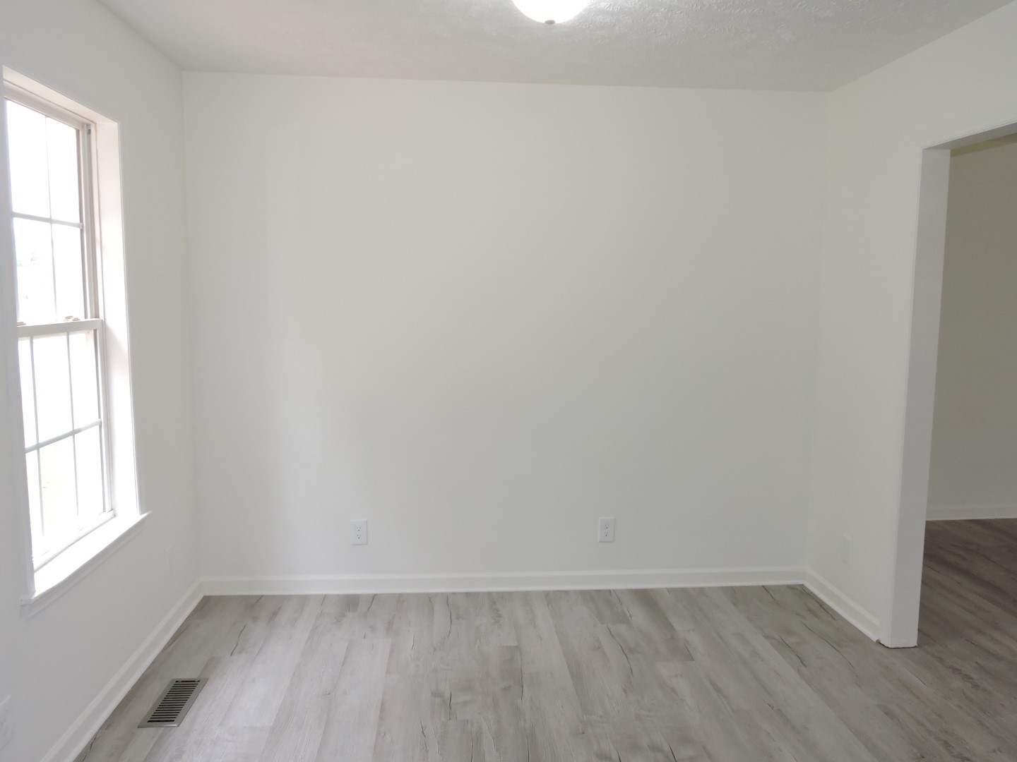 118 Ferrells Loop Road Manchester, TN 37355 - Photo 8 of 28 an empty room with wooden floor and windows
