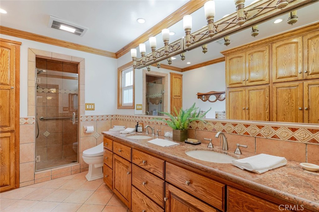835 North Lincoln Street Burbank, CA 91506 - Photo 13 of 38 a spacious bathroom with a granite countertop sink mirror and a shower