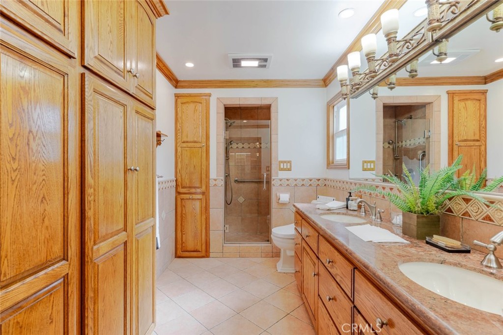 835 North Lincoln Street Burbank, CA 91506 - Photo 14 of 38 a bathroom with a granite countertop sink a mirror and a shower