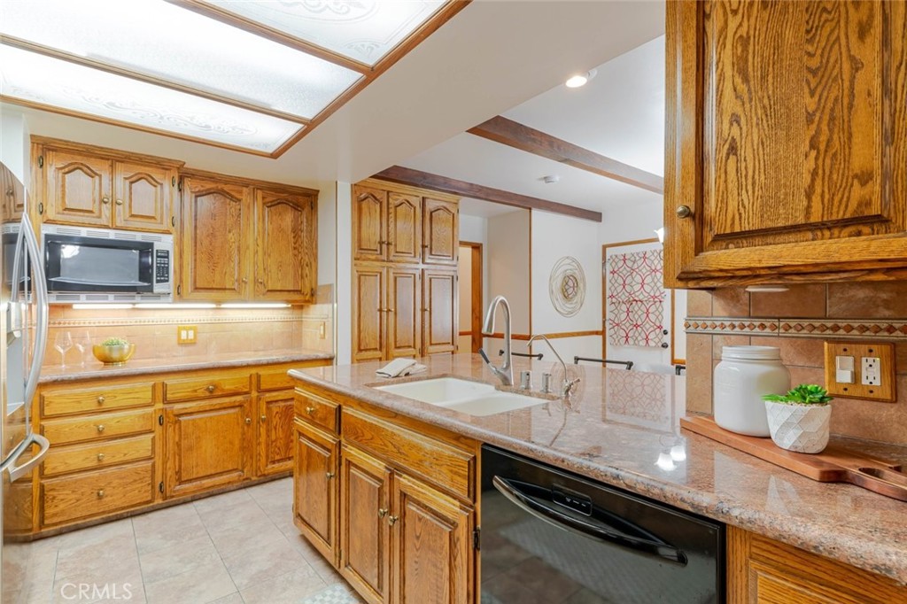 835 North Lincoln Street Burbank, CA 91506 - Photo 23 of 38 a kitchen with stainless steel appliances granite countertop a sink and cabinets