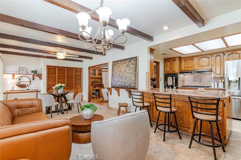 835 North Lincoln Street Burbank, CA 91506 - Photo 27 of 38 a living room with furniture a chandelier and a large window