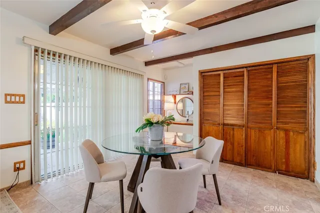 a dining room with furniture a chandelier and wooden floor