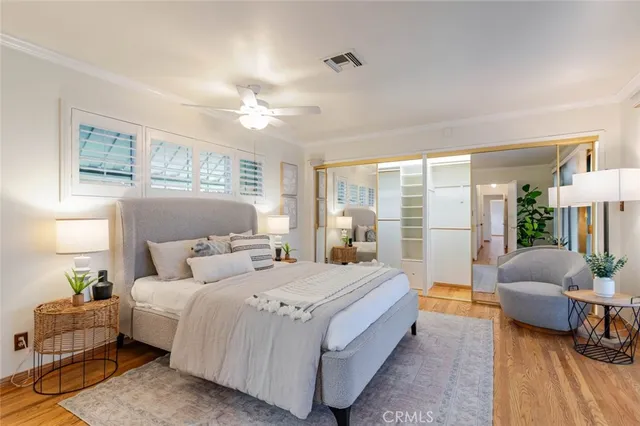 a bedroom with a large bed and a chandelier