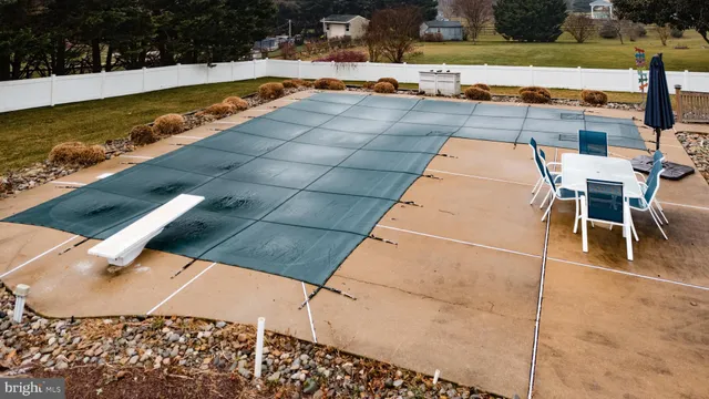 a view of swimming pool with seating area