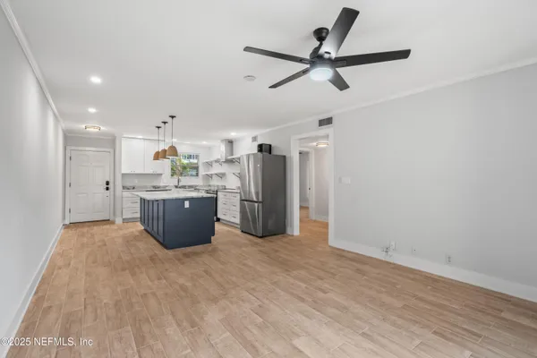 a view of a kitchen with a sink and stainless steel appliances