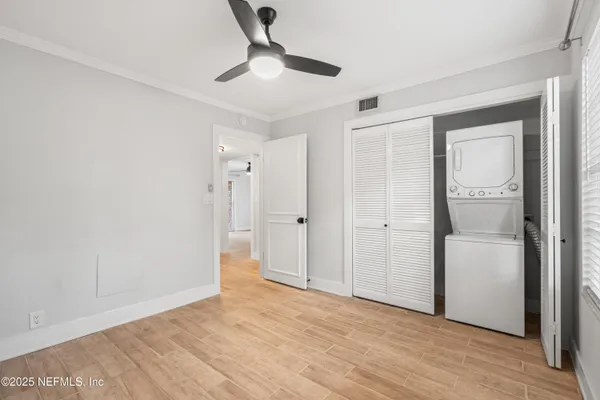 a view of empty room with wooden floor