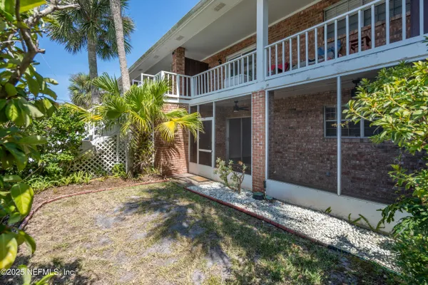a view of a house with a small yard and plants