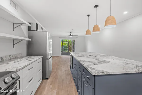 a bathroom with a granite countertop sink a toilet a shower and a mirror
