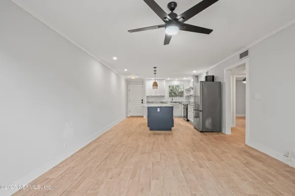a view of a kitchen with a sink and stainless steel appliances