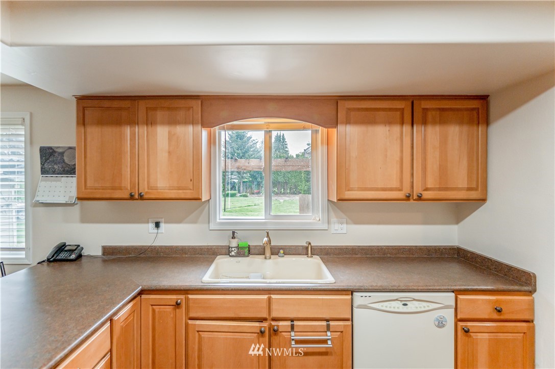 6891 Old Guide Road Lynden, WA 98264 - Photo 13 of 32 a kitchen with a sink cabinets and window