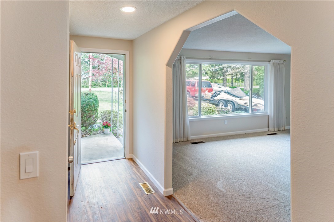 6891 Old Guide Road Lynden, WA 98264 - Photo 6 of 32 an empty room with wooden floor and windows