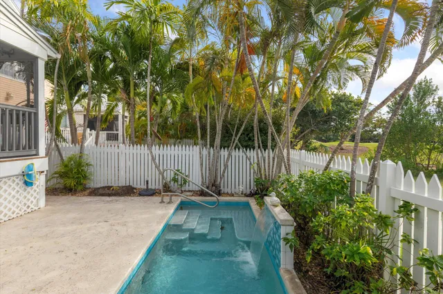 a dining room with furniture a window and wooden floor