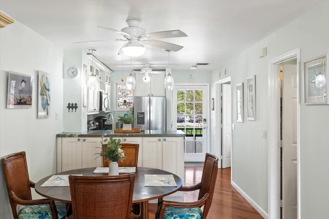 a view of a swimming pool with a yard and palm trees