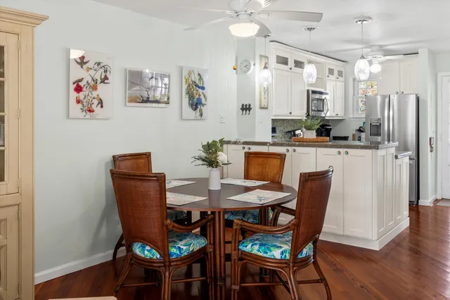 a view of a yard with plants and large trees
