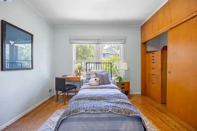 a bedroom with furniture and a rug