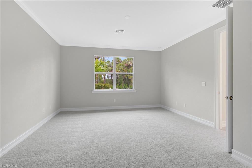 335 Tamarindo Lane Naples, FL 34114 - Photo 11 of 38 an empty room with windows