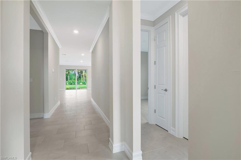 335 Tamarindo Lane Naples, FL 34114 - Photo 14 of 38 a view of a hallway with wooden floor