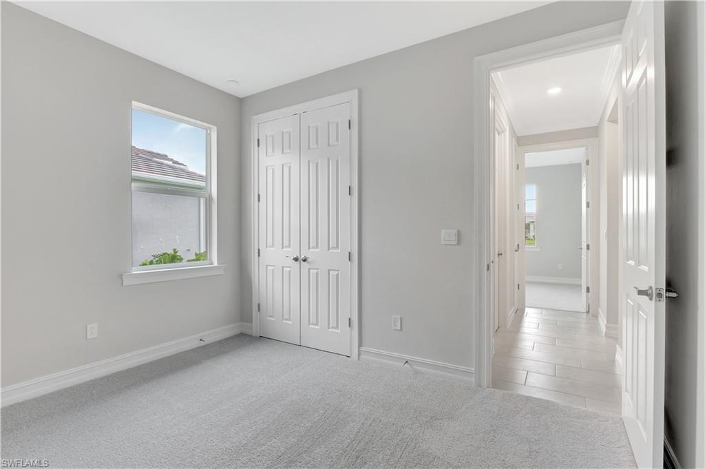 335 Tamarindo Lane Naples, FL 34114 - Photo 15 of 38 an empty room with windows and closet