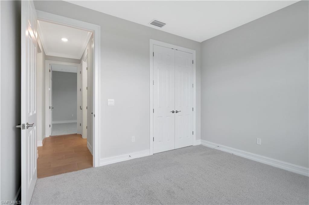 335 Tamarindo Lane Naples, FL 34114 - Photo 20 of 38 wooden floor and closet in a room