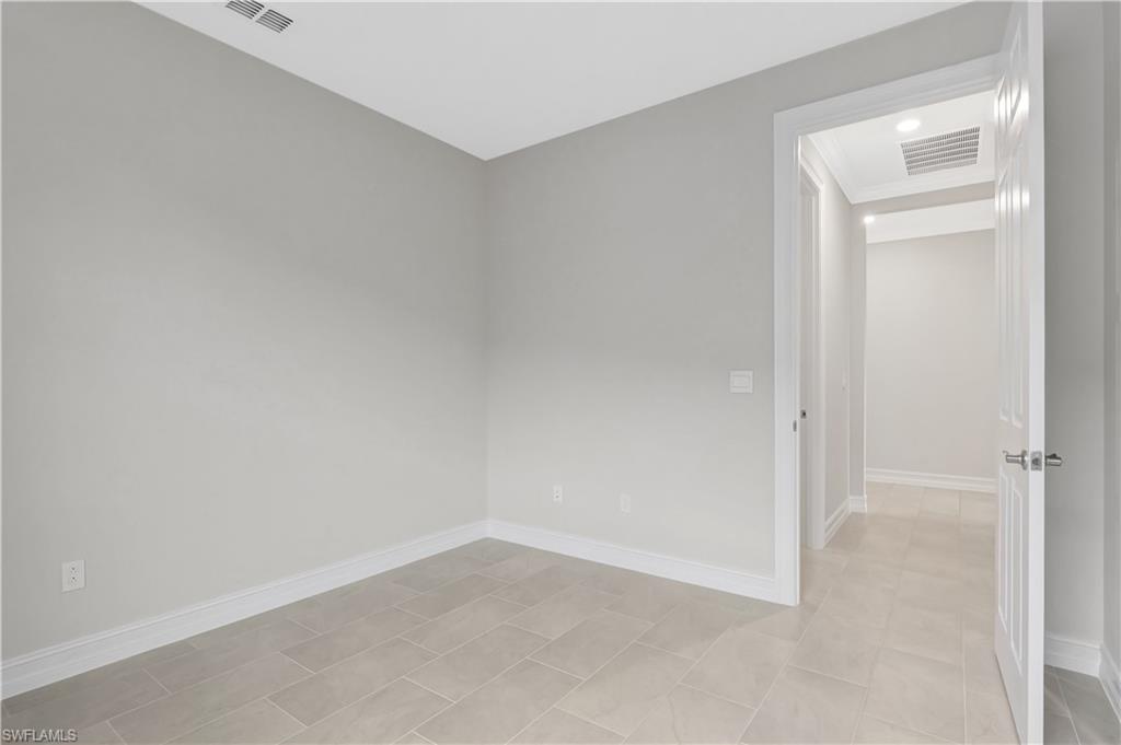 335 Tamarindo Lane Naples, FL 34114 - Photo 25 of 38 an empty room with a hallway