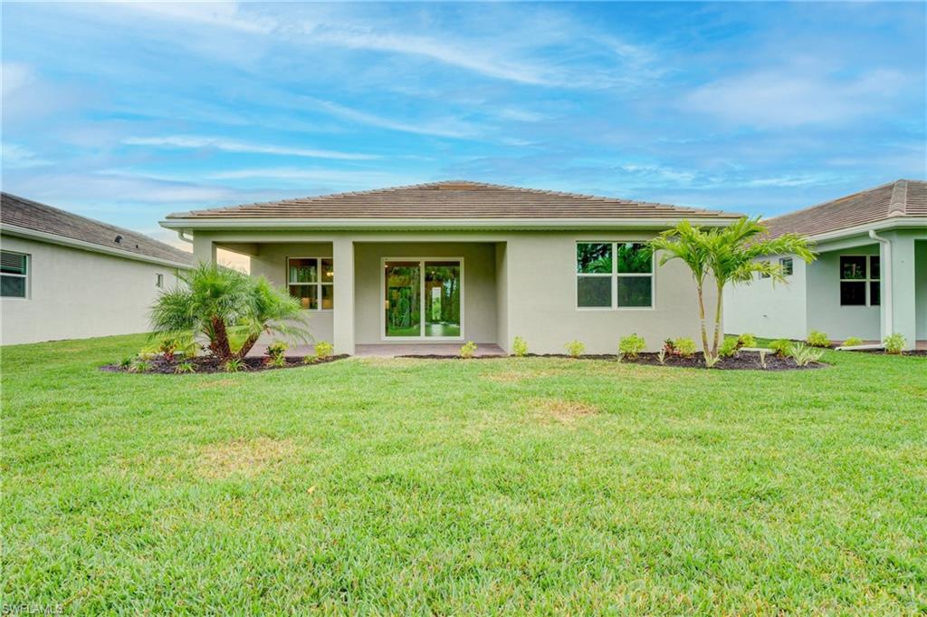 335 Tamarindo Lane Naples, FL 34114 - Photo 29 of 38 front view of a house with a yard