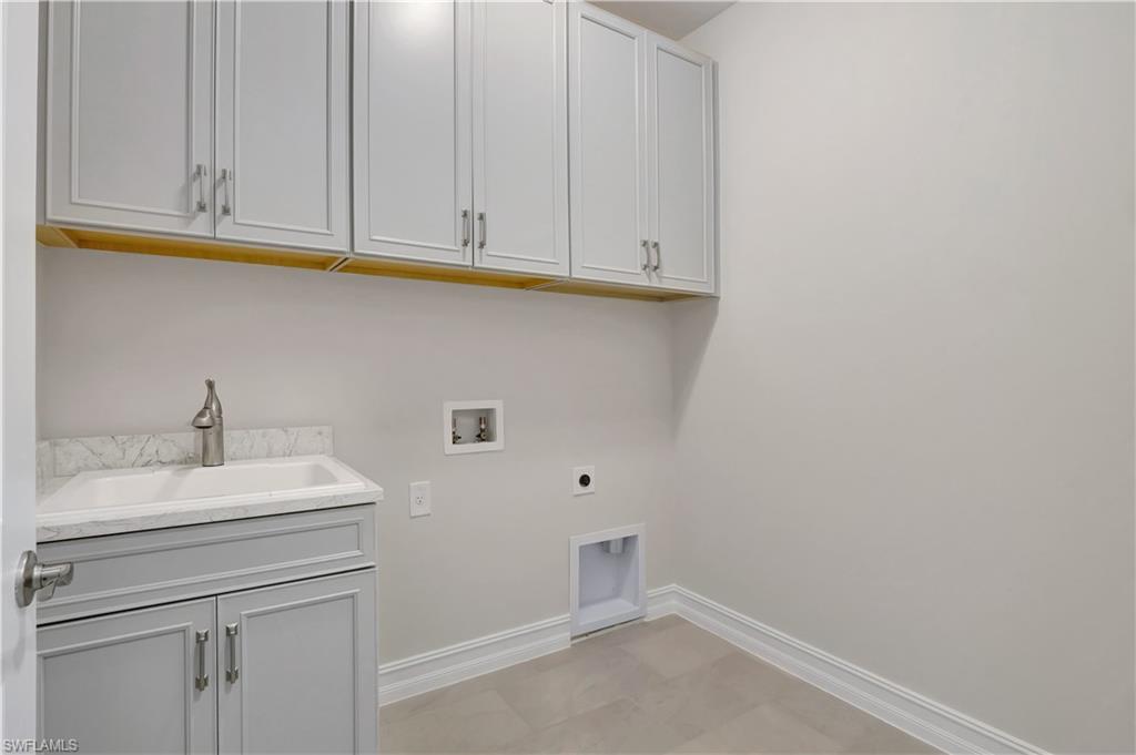 335 Tamarindo Lane Naples, FL 34114 - Photo 30 of 38 a bathroom with a sink and cabinets