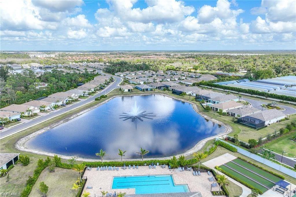 335 Tamarindo Lane Naples, FL 34114 - Photo 33 of 38 a view of a swimming pool with a yard