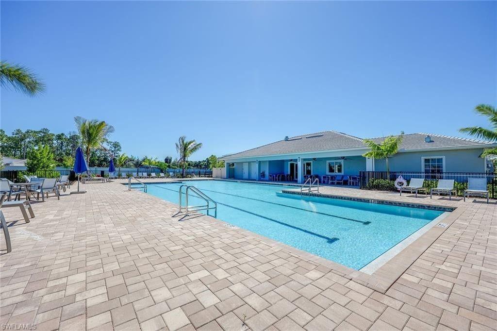 335 Tamarindo Lane Naples, FL 34114 - Photo 35 of 38 a swimming pool with outdoor seating and yard