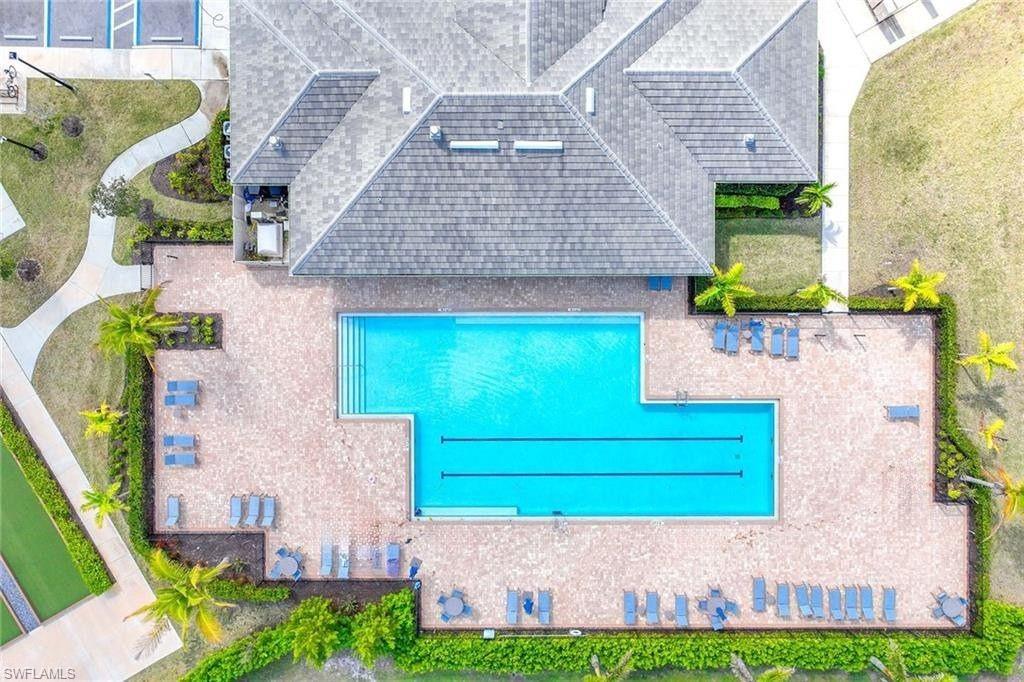 335 Tamarindo Lane Naples, FL 34114 - Photo 36 of 38 a front view of a house with a garden and plants