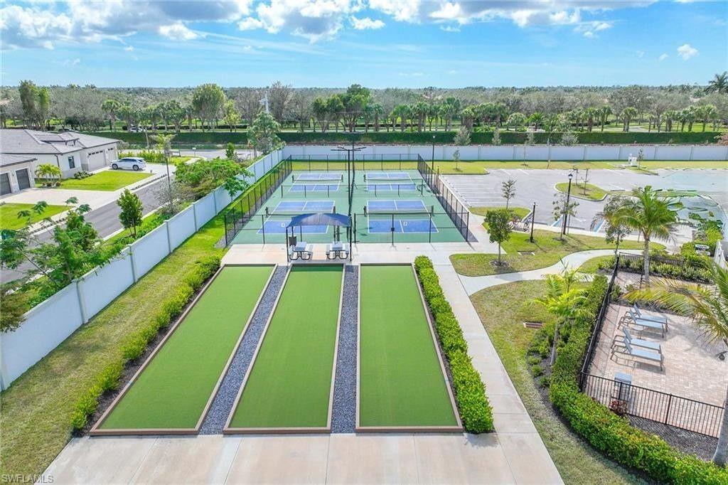 335 Tamarindo Lane Naples, FL 34114 - Photo 37 of 38 a view of swimming pool with a patio and a yard