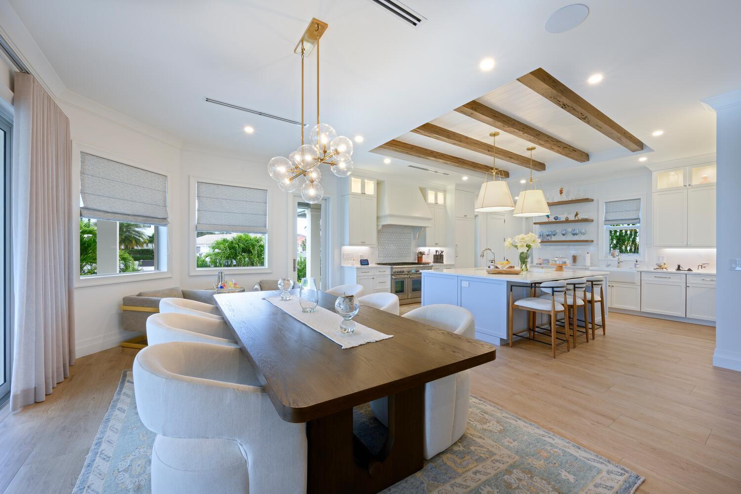 643 Pilot Road North Palm Beach, FL 33408 - Photo 11 of 73 a view of a dining room and livingroom with furniture wooden floor a chandelier