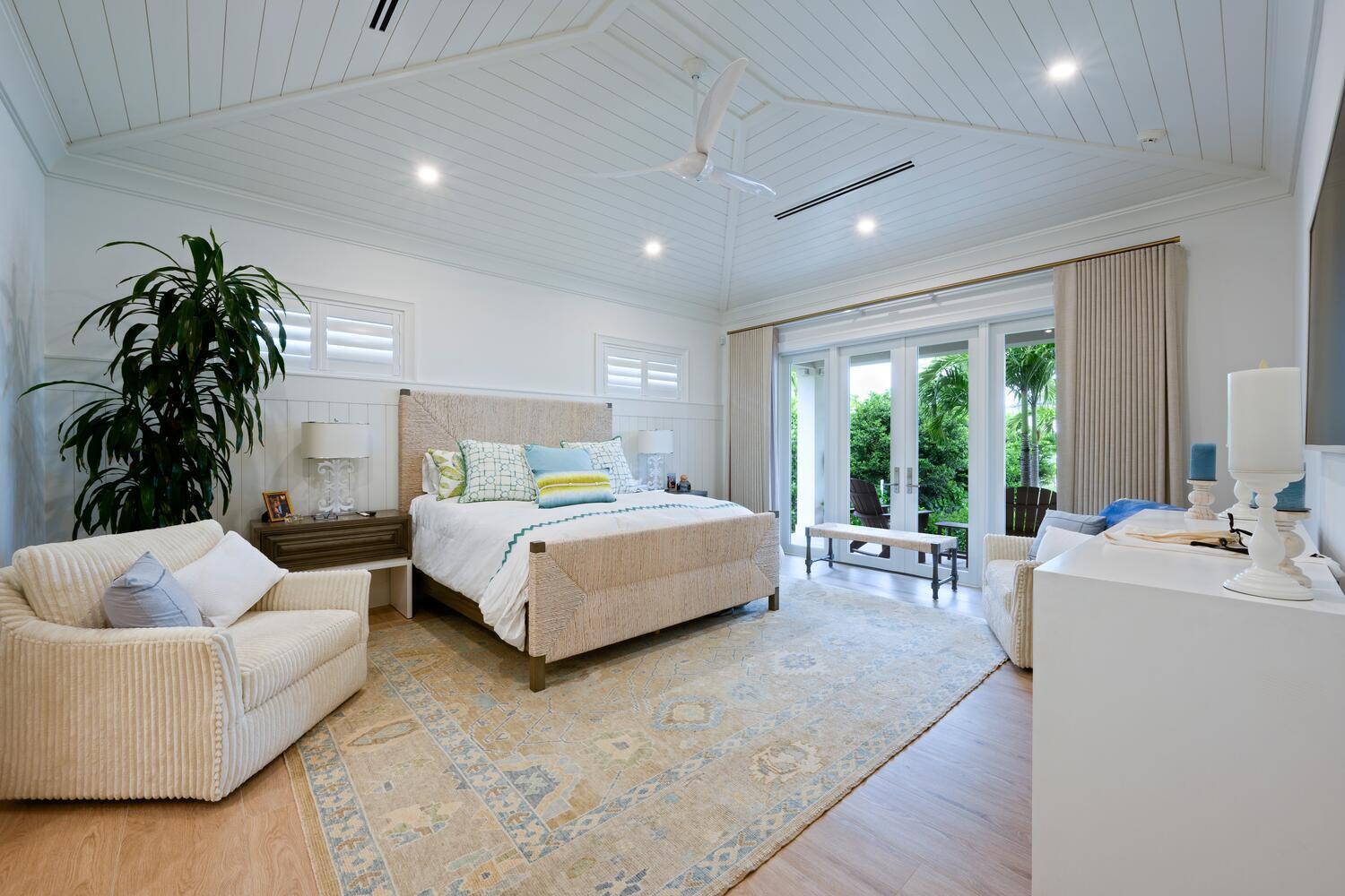 643 Pilot Road North Palm Beach, FL 33408 - Photo 13 of 73 a spacious bedroom with a large bed and a couch