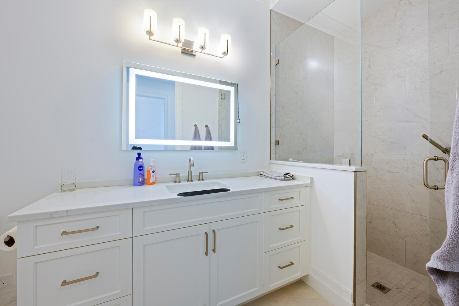 643 Pilot Road North Palm Beach, FL 33408 - Photo 28 of 73 a bathroom with a sink and a mirror