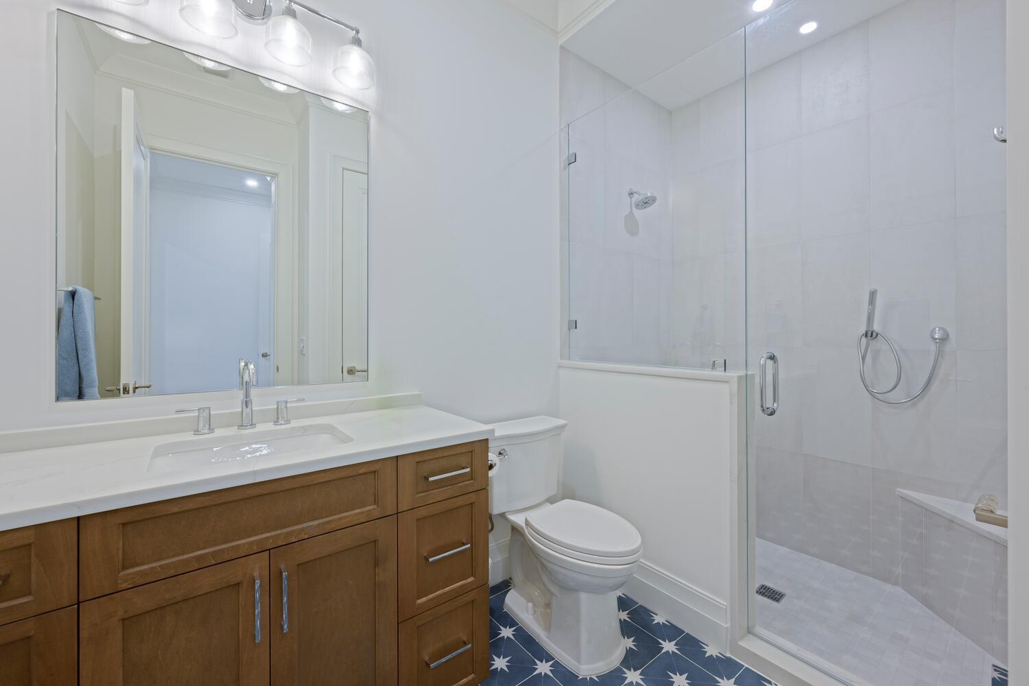 643 Pilot Road North Palm Beach, FL 33408 - Photo 32 of 73 a bathroom with a granite countertop sink toilet and shower