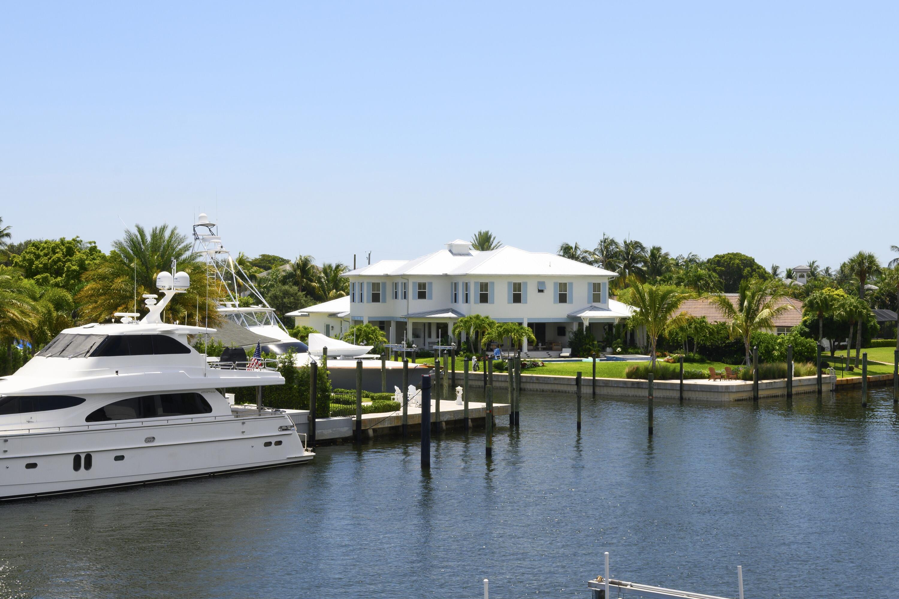 643 Pilot Road North Palm Beach, FL 33408 - Photo 49 of 73 a view of a swimming pool with outdoor seating and lake view