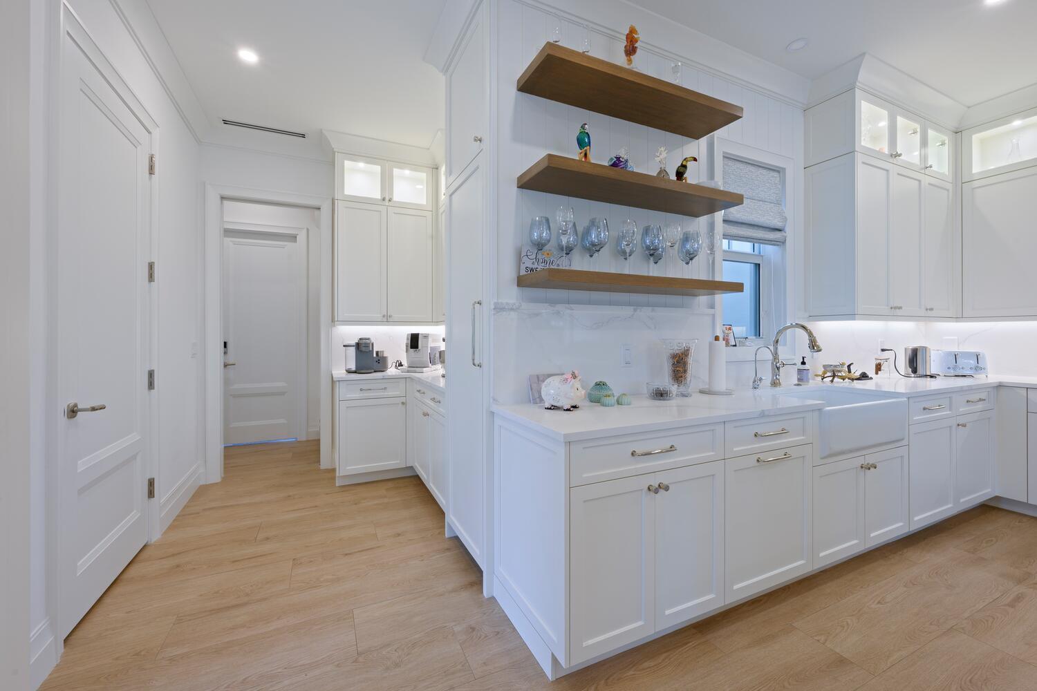 643 Pilot Road North Palm Beach, FL 33408 - Photo 10 of 73 a kitchen with cabinets a sink and a stove top oven
