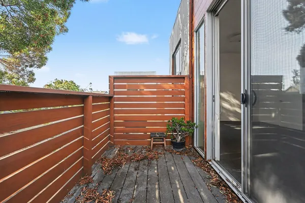 a view of outdoor space with wooden floor and windows