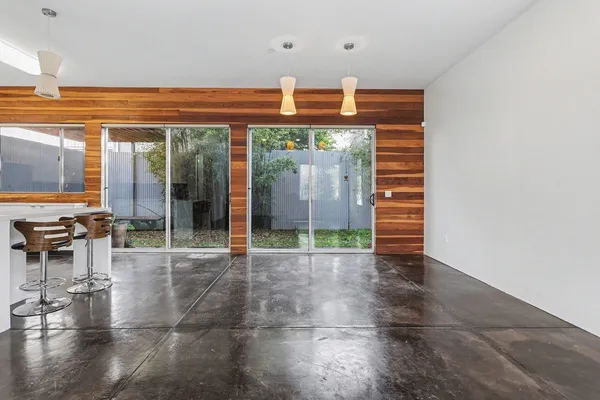 a view of a lobby with a floor to ceiling window and wooden floor