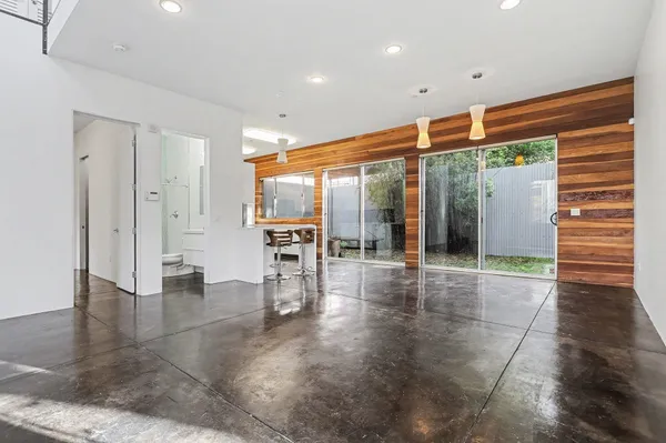 a view of an entryway with floor to ceiling window and wooden floor