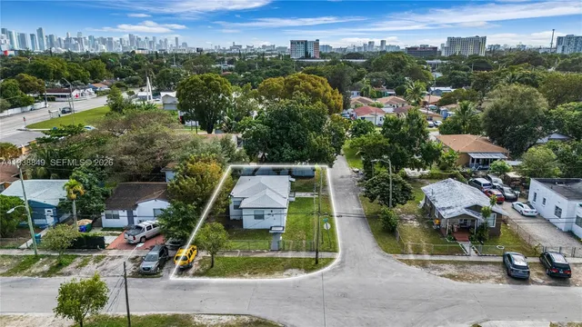 an aerial view of residential houses with outdoor space and parking